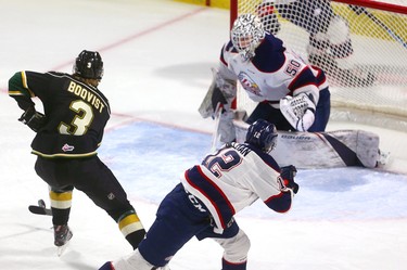 Adam Boqvist of the Knights can't control a rebound as he comes in on Saginaw goaltender Ivan Prosvetov while being checked by Mason Millman during the first period of their game Friday night at Budweiser Gardens in London, Ont.  Photograph taken on Friday January 11, 2019.  Mike Hensen/The London Free Press/Postmedia Network