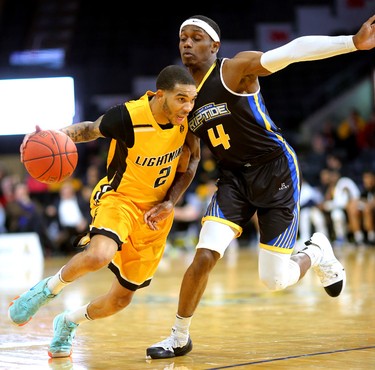 Xavier Moon of the Lightning drives against Brent Arrington of the Saint John Riptide during their Sunday afternoon game at Budweiser Gardens in London, Ont. The Lightning fell 107-98 against the Riptide who were 4-12 entering the game.
Photograph taken on Sunday January 13, 2019. 
Mike Hensen/The London Free Press/Postmedia Network