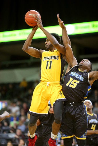 Jaylen Babb-Harrison of the Lightning drives in against Frank Bartley of the Saint John Riptide then makes a pass outside during their Sunday afternoon game at Budweiser Gardens in London, Ont. The Lightning fell 107-98 against the Riptide who were 4-12 entering the game.
Photograph taken on Sunday January 13, 2019. 
Mike Hensen/The London Free Press/Postmedia Network