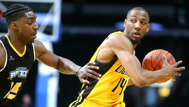 Marcus Capers of the Lightning looks to pass while being guarded by Frank Bartley of the Saint John Riptide during their Sunday afternoon game at Budweiser Gardens in London, Ont. The Lightning fell 107-98 against the Riptide who were 4-12 entering the game.
Photograph taken on Sunday January 13, 2019. 
Mike Hensen/The London Free Press/Postmedia Network