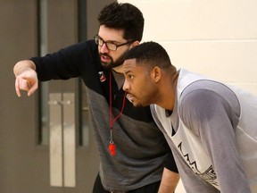 London Lightning head coach Elliott Etherington talks to Rudolphe (Rudy) Joly at his first practice Wednesday morning at the Central Y.  The 6'10" centre has played in the NBL before with the Windsor Express and St. John's Edge. (Mike Hensen/The London Free Press)