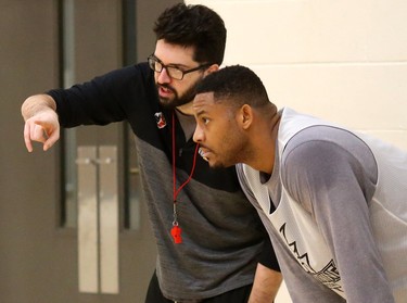 London Lightning head coach Elliott Etherington talks to Rudolphe (Rudy) Joly at his first practice Wednesday morning at the Central Y.  The 6'10" centre has played in the NBL before with the Windsor Express and St. John's Edge. (Mike Hensen/The London Free Press)