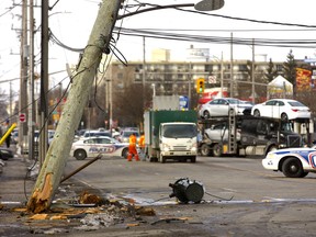A hydro pole is suspended by its high-tension lines after a white van struck and snapped the pole off at the ground level near the intersection of Adelaide Street and Lambton Street in London, Ont. on Wednesday January 16, 2019. The force of the collision caused a transformer to hit and appear to leak on the street. No word on injuries, but the street was closed for hours as hydro crews replaced the pole. Mike Hensen/The London Free Press/Postmedia Network