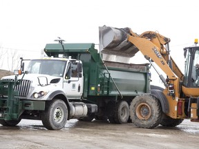 Equipment operator Al Baldest loads a city of London truck with road salt in preparation for a snowstorm expected this weekend  in London. Derek Ruttan/The London Free Press/Postmedia Network