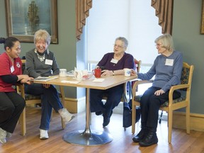 Clients of the Dearness Home's adult day program L to R Barb Johnston, Joan Mallard and Carol Howieson enjoy coffee, cookies and camaraderie.  With them is personal support worker student from Westervelt College Shelem Turan. (Derek Ruttan/The London Free Press)