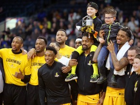 The London Lightning's Marvin Phillips and Mo Bolden hoist the 2019 Champion Child Joey Murray, of London and last year's champion Hunter Fernyc of Thunder Bay before their game against the Sudbury 5 on Sunday, to honour the Children's Health Foundation and the Children's Miracle Network. This year's champion Murray had Leukemia and was handed Thor's hammer by last year's representative Fernyc who had Hemophagocytic Lymphohistiotosis, a rare blood disease. Photograph taken on Sunday January 27, 2019.  Mike Hensen/The London Free Press/Postmedia Network