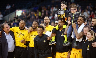 The London Lightning's Marvin Phillips and Mo Bolden hoist the 2019 Champion Child Joey Murray, of London and last year's champion Hunter Fernyc of Thunder Bay before their game against the Sudbury 5 on Sunday, to honour the Children's Health Foundation and the Children's Miracle Network. This year's champion Murray had Leukemia and was handed Thor's hammer by last year's representative Fernyc who had Hemophagocytic Lymphohistiotosis, a rare blood disease. Photograph taken on Sunday January 27, 2019.  Mike Hensen/The London Free Press/Postmedia Network