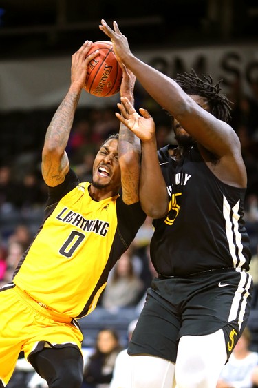 Mo Bolden of Lightning gets fouled by Isiah Johnson of the Sudbury 5, then makes the hoop and the foul shot for a badly needed three points  in the first half of their game against the Sudbury 5 at Budweiser Gardens. Photograph taken on Sunday January 27, 2019.  Mike Hensen/The London Free Press/Postmedia Network