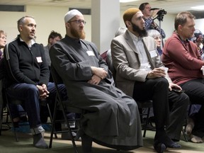 Imam Abd Alfatah Twakkal and approximately fifty others listen to MPP Terence Kernaghan speak during a public commemoration of the second anniversary of a massacre at a Quebec mosque. Derek Ruttan/The London Free Press/Postmedia Network