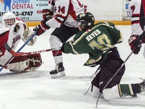 Even knocked down on his knees, St. Thomas Stars’ Adam Keyes still manages to get his shot away in first period. File photo