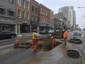 Workers continue repairs on a sinkhole created early Tuesday after a water main ruptured under Dundas Street, right outside the Central library branch. It's the second sinkhole on a major London roadway in the past week. (Patrick Maloney/The London Free Press)