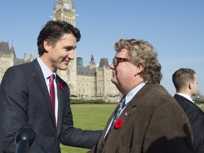 Prime Minister Justin Trudeau speaks Ed Holder. (Canadian Press files photo)