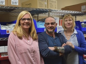 Regional HIV/AIDS Connection staff Sonja Burke, left, Blair Harvey and Karen Burton, with harm reduction supplies in the needle exchange room at 186 King Street. The city's temporary overdose prevention site, also at the location, is marking one year in operation. (Jennifer Bieman/The London Free Press)