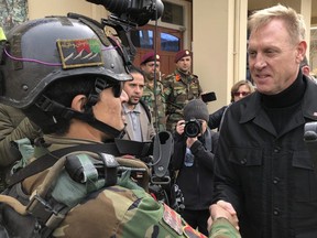 US. acting secretary of defense Pat Shanahan, appointed by President Donald Trump despite his lack of military experience, greets an Afghan commando at Camp Commando, Afghanistan, on Monday. The unannounced visit is the first for Shanahan as the U.S. tries to negotiate a settlement with Taliban rebels.  (Robert Burns/AP)