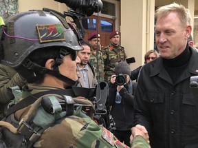 US. acting secretary of defense Pat Shanahan, appointed by President Donald Trump despite his lack of military experience, greets an Afghan commando at Camp Commando, Afghanistan, on Monday. The unannounced visit is the first for Shanahan as the U.S. tries to negotiate a settlement with Taliban rebels.  (Robert Burns/AP)