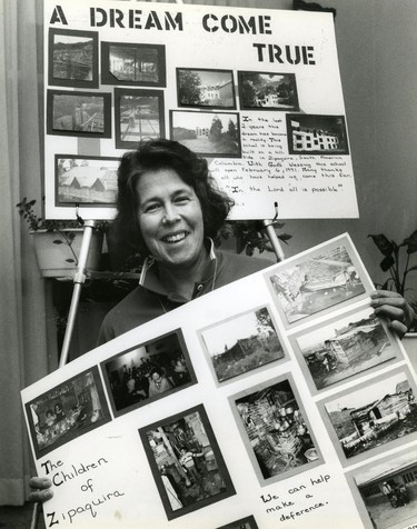 Maria Amaral of London shows two posters with photographs depicting people and buildings in Zipaquira Columbia, she and several others helped raise more than $50,000 to help build a school, 1990. (London Free Press files)