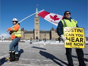 United We Roll convoy protesters stand outside the Parliament building in Ottawa on Tuesday, calling on the federal government to support Western Canada's energy industry.