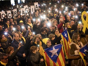 Pro independence demonstrators gather during a protest in Catalonia square in Barcelona, Spain, Tuesday, Feb. 12, 2019. A sensitive trial against a dozen Catalan separatist politicians and activists got underway Tuesday in Spain's Supreme Court amid protests by pro-independence supporters and a highly volatile political environment. Banner in Catalan reads "freedom politics imprisoned".