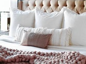 Luxurious-looking linens can make guests feel pampered at their home away from home. (Carla Choy, Decorist)