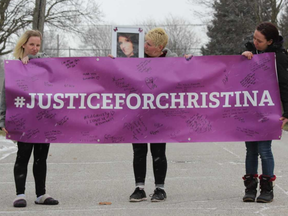 Megan Wilcox, left, Tracey Vondette Wilcox and Alicia Wilcox hold a banner honouring Christina Smith, who was killed in a hit-and-run on Feb. 8, 2018. Smith's family is holding a vigil Friday night to mark the one-year anniversary of her death. DALE CARRUTHERS / THE LONDON FREE PRESS