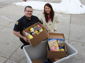 Correction officers Sean Dechene and Janet Laverty, who is also the president of the Ontario Public Service Employees Union local for correctional officers,, show some of the food collected during at a drive held Tuesday at London's Elgin-Middlesex Detention Centre in support of the London Food Bank. (JONATHAN JUHA, The London Free Press)