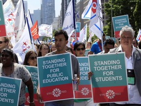 Ontario elementary teachers supporters make their way up University Ave in protest to the sex-ed rollback at Queen's Park in Toronto August 14, 2018. Stan Behal/Toronto Sun