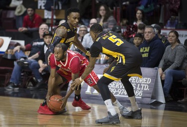 Windsor's Horace Wormely is double teamed by London's Alex Johnson, left, and Kevin Ware Jr. in NBLC action between the Windsor Express and the London Lightning at the WFCU Centre, Wednesday, February 6, 2019.  (DAX MELMER/Windsor Star)