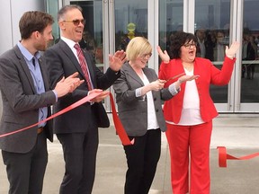 A group of federal and New Brunswick politicians take part in a ribbon-cutting ceremony as they open the centralized Public Service Pay Centre in Miramichi in May 2018. (THE CANADIAN PRESS/Michael MacDonald)