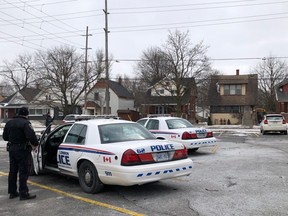 Two London police officers exit their cruisers near the scene of a shooting in the area of Florence Street and Kellogg Lane, just east of the Western Fair Sports Centre. A man suffered several gunshot wounds, police say. Photo taken Monday Feb. 25, 2019. (JONATHAN JUHA, The London Free Press)