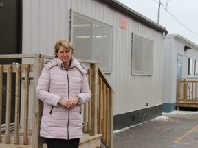 Jacquie Davison, superintendent of business with the London District Catholic school board, stands outside portables at St. Catherine of Siena elementary school – one of the schools in the board dealing with overcrowding – in the city’s north end. (JONATHAN JUHA, The London Free Press)