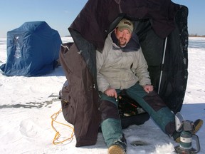 Sheltered: Kris Gagnier used a tent-like shelter to combat the extreme cold while ice fishing on Mitchell Bay in 2007.