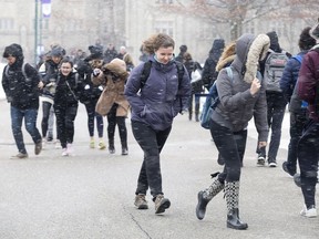 Students struggle against strong winds while traveling between classes at Western University in London, Ont. in this Free Press file photo