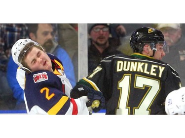Tyler Tucker of the Barrie Colts reacts after a high stick from Nathan Dunkley of the Knights during the first period of their OHL game at Budweiser Gardens in London on Friday night.  (Mike Hensen/The London Free Press)