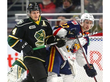 Will Lochead of the London Knights ties up Luke Bignell of the Barrie Colts during an early penalty kill after a high stick from Nathan Dunkley during the first period of their OHL game at Budweiser Gardens in London on Friday night.  (Mike Hensen/The London Free Press)