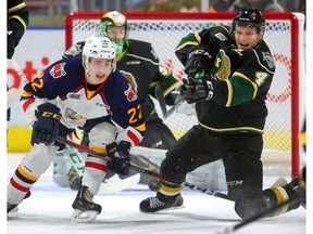 Knights defenceman Will Lochead fires the puck away from Luke Bignell of the Barrie Colts to clear the zone during an early penalty kill during the first period of their OHL game at Budweiser Gardens in London on Friday night.  (Mike Hensen/The London Free Press)
