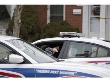 A woman speaks to police on scene at 67 Arbour Glen Crescent where a man died after being wounded by an arrow in London, Ont. on Tuesday February 5, 2019. (Derek Ruttan/The London Free Press)
