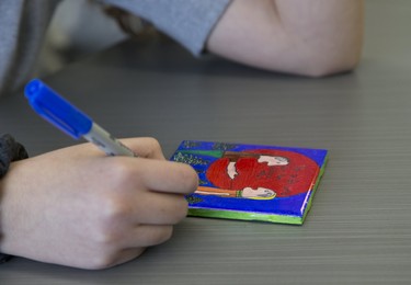 Oana (cct) Tibre, a grade 8 student at Holy Rosary Catholic School, colours a ceramic tile as part of a city wide indigenous reconciliation education project  London. Derek Ruttan/The London Free Press