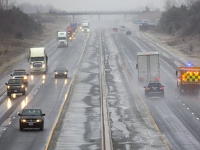 Highway 401 was a slippery mess on Feb. 6, 2019, with limited visibility with a combination of rain and freezing rain slowing traffic. Snowplows were in operation clearing slush of the road and salting to keep the road surface as ice free as possible.(Mike Hensen/The London Free Press)