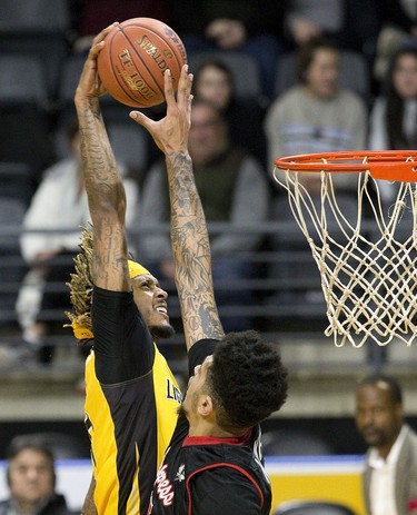 Seven foot tall Ty Walker of the Windsor Express stops a dunk attempt by 6 foot 10 inch tall Mo Bolden of the London Lightning in London, Ont. on Thursday February 7, 2019. Derek Ruttan/The London Free Press/Postmedia Network