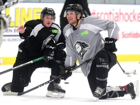 Gerard Keane and Cole Tymkin of the Knights chat as they watch a drill during practice at the Western Fair Sports Centre on Thursday.  Mike Hensen/The London Free Press/Postmedia Network