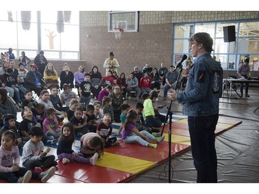 Wearing an image of Chanie Wenjack, Mike Downie speaks to students about reconciliation between Indigenous and non-Indigenous Canadians at Antler River elementary school  in Chippewa of the Thames on Friday. Downie's brother Gord Downie, lead singer of The Tragically Hip, created a collection of work about Wenjack's escape from a residential school. The 12-year-old perished trying walk 300 kilometres back home. (Derek Ruttan/The London Free Press)
