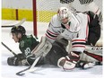 Alex Formenton of the London Knights slides into Owen Sound Attack goalie Mack Guzda during the first period of their OHL game at Budweiser Gardens on Friday night. The Knights won 6-3.  (Derek Ruttan/The London Free Press)