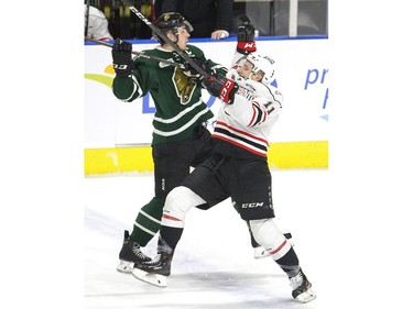 Evan Bouchard of the London Knights rebuffs Daylon Groulx of the Owen Sound Attack during the first period of their OHL game at Budweiser Gardens in London, Ont. on Friday February 8, 2019. (Derek Ruttan/The London Free Press)