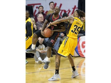 Chris Jones of the Windsor Express is fouled AJ Gaines of the London Lightning in the first half of their NBL game at Budweiser Gardens in London, Ont. on Sunday February 10, 2019. Derek Ruttan/The London Free Press/Postmedia Network