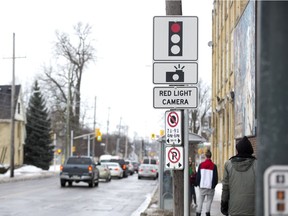 A sign alerts drivers to the presence of a red-light camera at the intersection of Adelaide Street and Queens Avenue in London. (Derek Ruttan/The London Free Press)