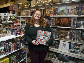 Kayla Gibbens, owner of Uber Cool Stuff, is surrounded by board games at her London store on Friday. Gibbens will host the annual Family Games Day at Fanshawe College on Family Day. (Derek Ruttan/The London Free Press)