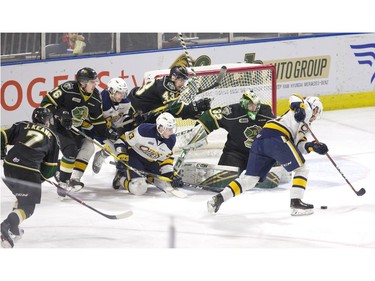 London Knights goalie Joseph Raaymakers keeps his cool as chaos abounds all around him in the first period of their game against the Erie Otters in London on Friday. (Derek Ruttan/The London Free Press)