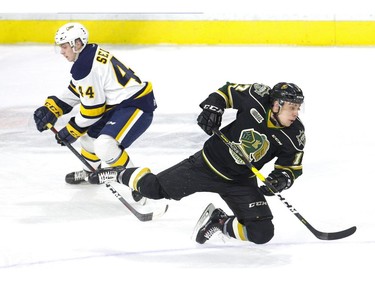 London Knight Nathan Dunkley is tripped by Erie Otter Brendan Sellan in the first period of their game in London on Friday. Sullan was assessed a minor penalty. Shortly after, the Otters scored a short-handed goal. (Derek Ruttan/The London Free Press)