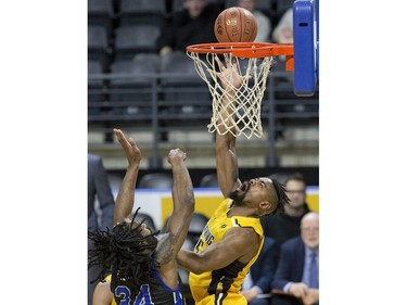 Marvin Phillips  lays up two points for the London Lightning while covered by Nigel Tyghter of the Kitchener Waterloo Titans during their game in London on Sunday Feb. 17, 2019. Derek Ruttan/The London Free Press