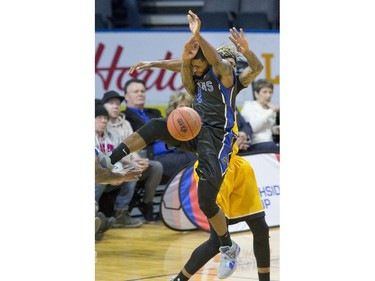 Ashton Smith of the Kitchener Waterloo Titans is fouled while shooting by Mo Bolden of the London Lightning during their game in London on Sunday Feb. 17, 2019. Derek Ruttan/The London Free Press